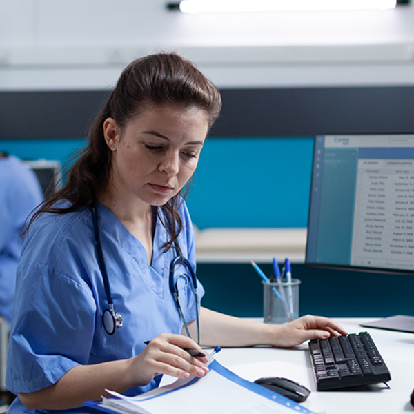 Reviewing patient data on a computer in a modern clinical setting.